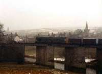 An unidentified class 25 with the Fraserburgh - Aberdeen goods, heads south from the village of Strichen across the viaduct over the river Ugie during a blizzard at the end of 1978. The viaduct still stands today, forming part of the Formartine and Buchan way.<br><br>[John Williamson /11/1978]