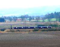 Late running 11.13 Perth to Glasgow passing the village of Forgandenny, approaching the Earn Viaduct and the closed station.<br><br>[Brian Forbes 11/12/2007]