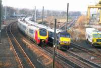A CrossCountry Voyager heading for Waverley meets a National Express East Coast service for Kings Cross at Portobello on 14 December 2007. The line from South Leith and the docks comes in centre right alongside the former BR Freightliner terminal.<br><br>[John Furnevel 14/12/2007]