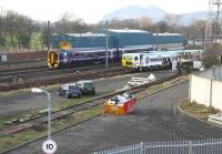 A 158 off the Newcraighall branch heading for Dunblane passes the PW sidings at Portobello on 14 December. The building in the background houses the Craigentinny wheel lathe and beyond that stands Arthurs Seat.<br><br>[John Furnevel /12/2007]