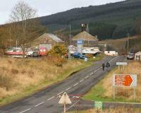 View north towards the former Kielder station (Renamed Kielder Forest in 1948) on 7 November, with the overgrown trackbed of the Border Counties Railway running off to the left of the road on its way to Riccarton Junction. In the background stands part of the massive Kielder Forest itself.<br><br>[John Furnevel 07/11/2007]