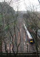 Eastbound service about to enter The Mound tunnel. Castle to left and The Caley top centre. New equipment for overhead wires lies by the trackbed.<br><br>[Ewan Crawford 24/12/2007]