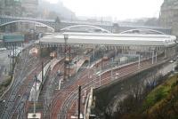 The morning after the night before.... view over Waverley on a misty New Years Day, 1 January 2008. Some of the various festive season fairground attractions can be seen along Princes Street and Market Street but the most notable feature has to be the North Bridge - without a bus in sight!<br><br>[John Furnevel 01/01/2008]