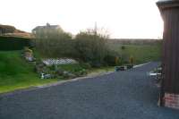 Platform scene at Woodburn on 7 November 2007. View is southwest towards Reedsmouth. The original roadbridge to the right, that carried the A68 over the trackbed, has now been turned into an embankment [with thanks to the lady of the house].<br><br>[John Furnevel 07/11/2007]