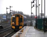 Train for Dunblane arriving at Stirling in monsoon conditions.158705<br><br>[Brian Forbes /12/2007]