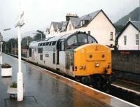 37430 <I>Cwmbran</I> stands at Fort William platform 2 on a cold, wet afternoon in October 1997. The locomotive will take out that days Fort William portion of <I>The Highland Sleeper</I> as far as Edinburgh Waverley. <br><br>[David Panton /10/1997]
