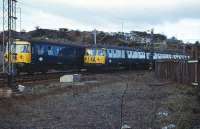 Class 303 units 037 and 058 pass on the Balloch line at Dalreoch Junction on 15 April 1973 when engineering works resulted in a shuttle operation running beween Balloch and Dumbarton Central.<br><br>[John McIntyre 15/04/1973]