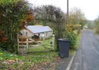 Looking west from the village of Kershopefoot on 3 November 2007 towards the site of the station and level crossing. While the platforms, signal box, crossing gates etc have long gone, the building with the new roof on the left is the former station house. The border lies a short distance off to the right of the picture.<br><br>[John Furnevel 03/11/2007]