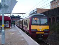 320 302 stops at Bellgrove with an Airdrie service on 12 January 2008. Standing above the rear of the train on the other side of Bellgrove Street are the remains of the once extensive Glasgow Cattle Market.  <br><br>[David Panton 12/01/2008]