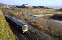 View east over part of Burntisland docks on 16 January 2008, with an Edinburgh bound 170 slowing for the stop at Burntisland station. The flat area in the background was once covered by sidings, usually occupied by trainloads of Fife coal awaiting shipment.<br><br>[Bill Roberton 16/01/2008]