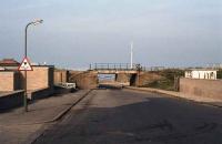 A view familiar to generations of Fraserburgh folk (of a certain age). Looking east down Kessock Road towards the beach in June 1980. The Aberdeen to Fraserburgh line was lifted by this time, but the bridges and solum survived for a short while afterwards. This view has now completely disappeared, including the promenade bridge, (just visible behind the railway bridge), which has also been filled in.<br><br>[John Williamson /06/1980]