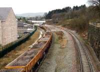 At one time a key location on the Midland Railway Manchester - Sheffield - St Pancras routes, Chinley station once boasted 5 through platforms and a bay. The current station, now an island platform, opened in 1902 due west of the original, is seen here looking towards New Mills. A class 60 locomotive waits with a ballast train on 27 January while a PW trolley is being loaded on the up line.<br><br>[John McIntyre 27/01/2008]