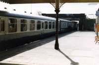 A fine rake of refurbished Mark 1 coaches about to leave Inverurie for Aberdeen behind 27006 (or 27008), in the spring of 1981.<br><br>[John Williamson /04/1981]