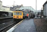 Passengers boarding a Dalmuir service formed by 303 027 at Hamilton Central in March 1985.<br><br>[David Panton /03/1985]