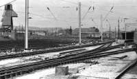 Looking back to Carnforth from a southbound train crossing from the Furness lines in May 1972. Several diesel locomotives are in the yard with the old 10A shed on the left of the picture. A start has been made on extending WCML electrification north with masts in place but no overhead conductor wires yet attached.     <br><br>[John McIntyre 30/05/1972]