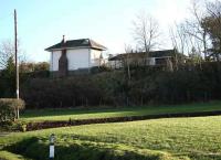 Less than 10 miles north from Hawick on the Waverley route stood Belses station. Closed in 1969, it has since been converted to residential accomodation and is seen here, standing on its embankment, on 6 February 2008. The view looks east across the driveway from a layby alongside the B6400 road. (The rail bridge that once spanned the road immediately north of the station is long gone.) [See image 28694] <br><br>[John Furnevel 06/02/2008]