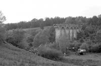 View over the partially demolished Tarras Viaduct south of Langholm in October 1987. The old viaduct was earmarked for demolition after being declared unsafe.... so unsafe it took two attempts to bring it down using explosives.<br><br>[Bruce McCartney 10/10/1987]