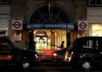 Looking south across Kensington High Street towards the entrance to the London Underground station late in the evening on 24 July 2005.<br><br>[John Furnevel 24/07/2005]