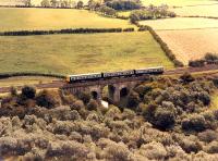 DMU heading east viewed from the top of the Waterside bing in 1988. Near here an east facing junction was made with a spur from the Monkland and Kirkintilloch Railway.<br><br>[Ewan Crawford //1988]