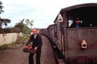 <I>The great Penton tomato rescue - 1967</I>. The pickup freight from Kingmoor serving Langholm and Newcastleton via Riddings Junction, stands at Penton in August 1967. Penton signal box was due to close and the signalman is in the process of retrieving his tomato plants. The freight, hauled by an EE Type 1, contained an extra brake van for members of the Border Railway Society. This particular trip was due to be the last freight to Langholm but the service was reprieved a further twice. The guard is Jim Bee, a Carlisle man on what was a regular turn for him.<br><br>[Bruce McCartney /08/1967]