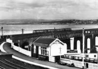 Taken from a b&w postcard. A four car 101 sets out over the Tay Bridge northwards towards Dundee. The Wormit up platform is in pristine condition. Date mmm...late 1950s at a guess.<br><br>[Brian Forbes Collection //]