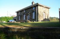 The converted station building still standing on the platform at Reedsmouth, seen here on 5 November 2007 looking northeast from the trackbed of the Border Counties line to Riccarton Junction. The Wansbeck Valley line to Morpeth ran along the far side of the wide island platform.<br><br>[John Furnevel 05/11/2007]