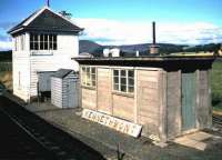 The signal box at Kennethmont, on the north side of the Inverness - Aberdeen main line, photographed in August 1985, with the nameboard from the former station (closed in 1968) standing alongside.<br><br>[David Panton /08/1985]