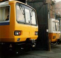 Pacer 143020 stands at Gosforth Depot in 1987, with a Tyne & Wear Metro unit in the background. <br><br>[Colin Alexander //1987]