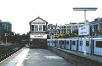 View south at Kensington Olympia in July 1986 shortly after the appearance of regular InterCity traffic on the West London Line. A District Line service to High Street Kensington waits to depart from the bay platform on the right.<br><br>[David Panton /07/1986]