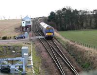 New signalling equipment to the left as an Aberdeen 170 passes Usan cabin and enters the single line section to Montrose in March 2008. The Cabin will be superceded under the local resignalling scheme. The level crossing leads nowhere, it is a means for NR to place road/rail vehicles on/off the tracks. [See image 41879]<br><br>[Brian Forbes 02/03/2008]