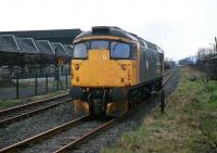 In April 1989, a Class 26 runs around its train of molasses tanks at Cambus Junction.<br><br>[Mark Dufton /04/1989]