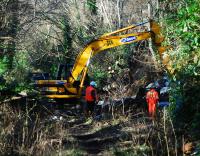 Looking north-west at repairs to the West Highland Railway (embankment to the right). The photograph is taken from the overgrown course of the old line to Faslane, looking to Faslane.<br><br>[Ewan Crawford 04/03/2008]