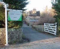 Railway Cottage was built to be Borwick Station but when the railway arrived it was in the wrong location and an identical building [See image 18286] was built alongside the line, about 100 yards away. The station that has never seen any trains! <br><br>[Mark Bartlett 15/02/2008]