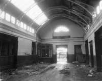 The booking hall of Fraserburgh passenger station in 1979, looking south towards the exit to the platforms. The ticket offices were on the left, and waiting rooms on the right. To the left of the door is a John Menzies kiosk which also opened out to the platform side.<br><br>[John Williamson 02/11/1979]