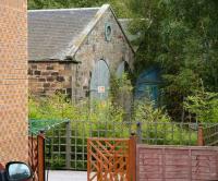 View east down the drive of a house in Golf Street, Ladybank from the road on 20 Sept 2007. On the other side of the line stands part of the works built by the EP&D circa 1848 (a running shed stood to the south nearer the junction). Lattery this building was used as a wagon repair shop, then an S & T store. [See image 16665]<br><br>[John Furnevel 20/09/2007]