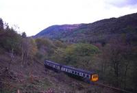 A DMU bound for Llandudno Junction in July 1986, photographed near Dolwyddelan on the Blaenau Ffestiniog branch.<br><br>[Ian Dinmore /07/1986]