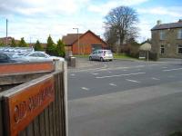 View north over the site of the former level crossing at Grimsargh on 18 March. The line would have run through the bungalow now built on the far side of the road. Note the sign on the fence (left) which provides one of the few remaining clues that a railway once passed through here.<br><br>[John McIntyre 18/03/2008]