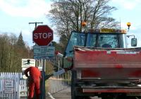 Tractor driver operating the lever controlling the barriers at Hospital Mill level crossing near Springfield.<br><br>[Brian Forbes 27/03/2007]