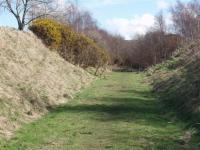 This deceptively quiet and peaceful cutting is less than 200 yards from the WCML and the M6 motorway. The location, now a private nature reserve, can be reached along a permissive pathway along the old trackbed from Garstang. The Royal Train was stabled here overnight on at least 2 occasions during WWII as a safe place on the way to Scotland. (Map Ref SD 505455). <br>
<br><br>[Mark Bartlett 30/03/2008]