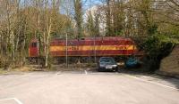 EWS 60065 hiding at the rear of a car park on the Whatley Quarry (Hanson Aggregates) branch near Frome, Somerset, on 6 April 2008. <br><br>[Peter Todd 06/04/2008]