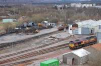 EWS 66108 looks lonely in Fort William depot yard on Thursday 10 April 2008. The Mallaig line can be seen turning off to the left and Lochaber High School stands in the right background.<br><br>[Bill Roberton 10/04/2008]