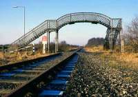 The fine footbridge which used to stand across the Alloa-Kincardine line on the eastern outskirts of Alloa. This westward view is now totally dominated by the new bridge of the Alloa eastern bypass.<br><br>[Mark Dufton /11/1985]