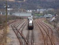 View over the yard at Fort William on 10 April with a train for Mossend awaiting the arrival of EWS 66108.  Two bogie bolsters loaded with aluminium slabs are nearest the camera and the rusty line to Mallaig is on right.<br><br>[Bill Roberton 04/04/2008]