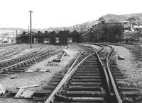 The approach to Perth shed from the station in 1970, some three years after official closure.  Demolition work and tracklifting are underway with redundant track lengths stacked on the former shed roads.<br><br>[John Furnevel 25/05/1970]