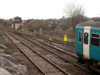 The dolly is off and 153328 moves forward to cross to the up line and travel the short distance to Clitheroe before forming a Manchester Victoria service. The branch to the Ribble Cement works can be seen trailing in behind the train.<br><br>[Mark Bartlett 19/04/2008]