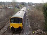 150143 and 153328 draw to a halt at Horrocksford Junction having run ECS from Clitheroe station to reverse and cross over before forming a Clitheroe to Manchester service. The signal controls the exit from the Castle Cement terminal where the new thrice weekly trains to Mossend originate. SD 746426<br><br>[Mark Bartlett 19/04/2008]