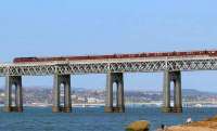 First outing of <I>The Royal Scotsman</I> in 2008. The train, hauled by 47804, is seen crossing the Tay Bridge on 21 April heading for Dundee and eventually Keith. Below the bridge a father watches his son and labrador at play.<br><br>[Brian Forbes 21/04/2008]