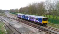 A Blackpool South - Colne service formed by 150 144 at Lostock Hall Junction on 19 April. Lostock Hall station stands in the background.<br><br>[John McIntyre 19/04/2008]