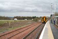 The area between the station and the M8 motorway at Uphall, including the tree screening, has now been cleared in preparation for a second platform and additional infrastructure. View east on 24 April 2008 as a Bathgate - Waverley service pulls away.<br><br>[John Furnevel /04/2008]