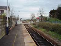 Moss Side station was closed in 1961 but the platforms were left in situ and when the line was singled it was reopened in 1983. View across the level crossing towards Kirkham - disused down platform on the right. <br><br>[Mark Bartlett 26/04/2008]
